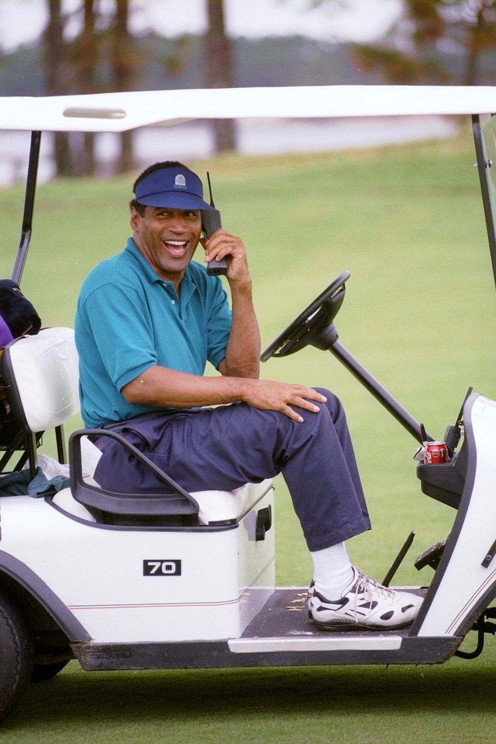 O.J. Simpson keeps in touch in his golf cart.