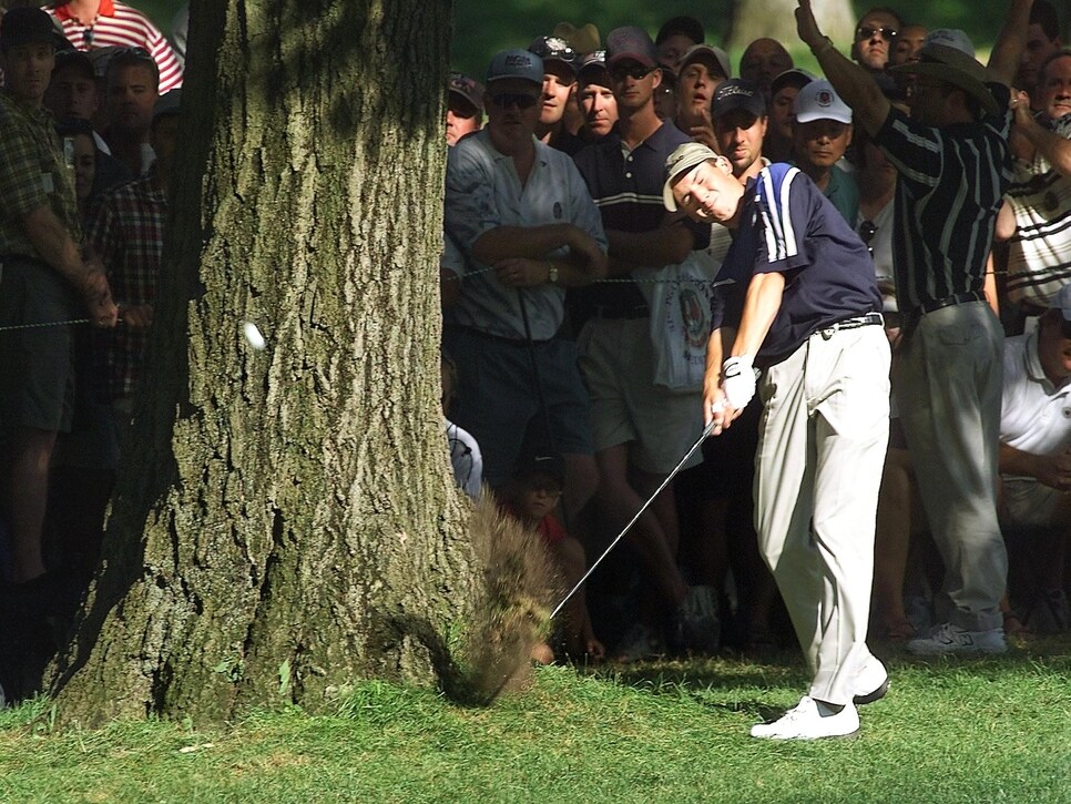 Sergio Garcia of Spain hits past a tree on the 16t