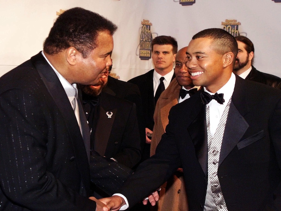 Boxing great Muhammad Ali shakes hands with golfer