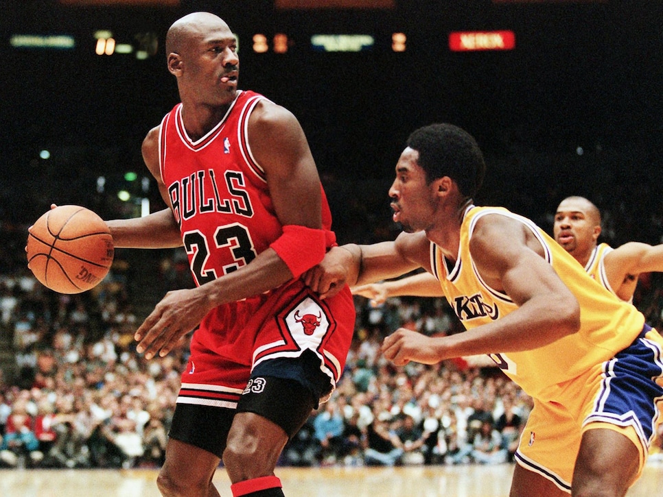 Michael Jordan of the Chicago Bulls (L) eyes the b