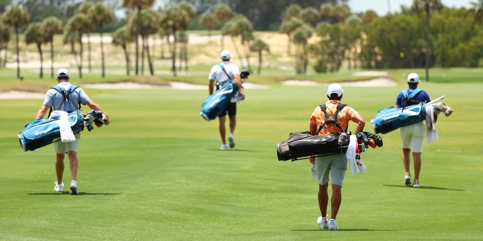 JUNO BEACH, FLORIDA - MAY 17: (L-R) Rory McIlroy of the American Nurses Foundation team, Dustin Johnson of the American Nurses Foundation team, Rickie Fowler of the CDC Foundation team and Matthew Wolff of the CDC Foundation team walk down the first fairway during the TaylorMade Driving Relieve Supported By UnitedHealth Group on May 17, 2020 at Seminole Golf Club in Juno Beach, Florida. (Photo by Mike Ehrmann/Getty Images)