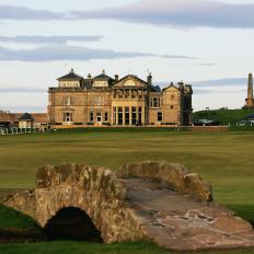 ST ANDREWS, SCOTLAND - JUNE 4: The Swilcan Bridge with the par 4 18th hole and the Royal and Ancient Golf Club of St Andrews Clubhouse behind on the Old Course at St Andrews, on June 4, 2004 in St Andrews, Scotland.  (Photo by David Alexander/Getty Images)