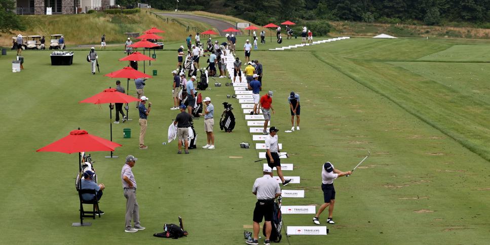 CROMWELL, CONNECTICUT - JUNE 24:  Tournament golfers warm up on the practice tee during a practice session of the Travelers Championship on June 24, 2020 at the TPC River Highlands  in Cromwell, Connecticut. (Photo by Elsa/Getty Images)