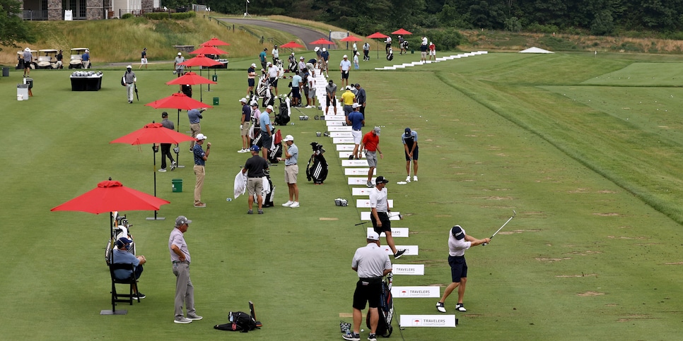 CROMWELL, CONNECTICUT - JUNE 24:  Tournament golfers warm up on the practice tee during a practice session of the Travelers Championship on June 24, 2020 at the TPC River Highlands  in Cromwell, Connecticut. (Photo by Elsa/Getty Images)