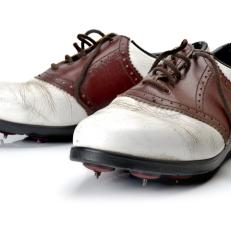pair of old golf shoes shot on white