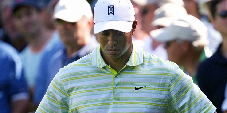 Mamaroneck, UNITED STATES:  Tiger Woods of the US holds his head down after hitting it into the ruff along the 15th fairway during the opening round of the 106th US Open Golf Tournament 15 June 2006 at the Winged Foot Golf Club in Maraoneck, New York.    AFP PHOTO / TIM SLOAN  (Photo credit should read TIM SLOAN/AFP via Getty Images)