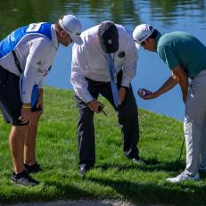 LAS VEGAS, NV - OCTOBER 16: A PGA rules official (center) examines lie the of Colin MorikawaÄôs  ball on hole number four during the second round of The CJ Cup at Shadow Creek on October 16, 2020 in Las Vegas, NV.   (Photo by Matthew Bolt/Icon Sportswire via Getty Images)