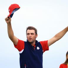 KOHLER, WISCONSIN - SEPTEMBER 26: Scottie Scheffler of team United States and wife Meredith Scudder celebrate on the 15th green after defeating Jon Rahm of Spain and team Europe 4&3 during Sunday Singles Matches of the 43rd Ryder Cup at Whistling Straits on September 26, 2021 in Kohler, Wisconsin. (Photo by Mike Ehrmann/Getty Images)