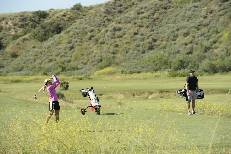 /content/dam/images/golfdigest/fullset/2021/10/woman man hitting carrying bag.jpg