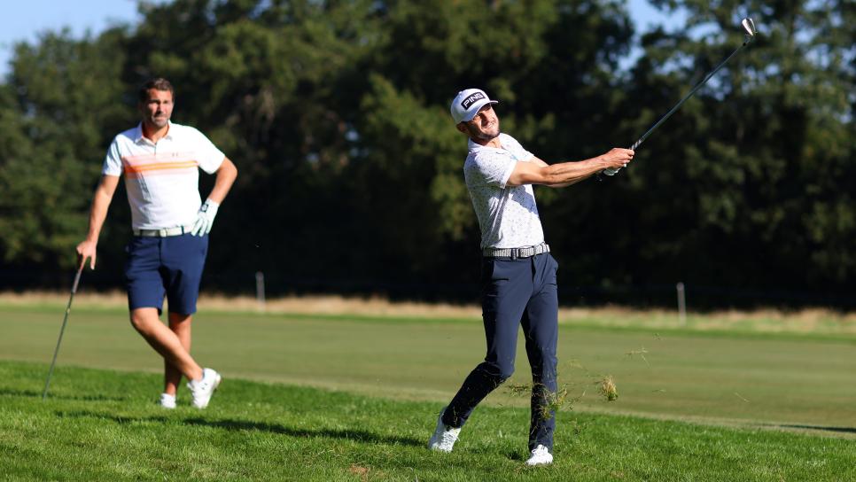VIRGINIA WATER, ENGLAND - SEPTEMBER 08: Adam Lallana plays a shot from the rough as Eddie Hearn looks on during the Pro-Am event prior to The BMW PGA Championship at Wentworth Golf Club on September 08, 2021 in Virginia Water, England. (Photo by Richard Heathcote/Getty Images)