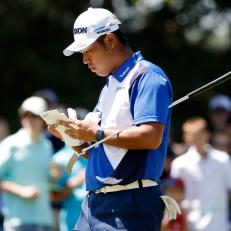 ATLANTA, GEORGIA - SEPTEMBER 04: Hideki Matsuyama of Japan checks his yardage book on the first green during the third round of the TOUR Championship at East Lake Golf Club on September 04, 2021 in Atlanta, Georgia. (Photo by Cliff Hawkins/Getty Images)