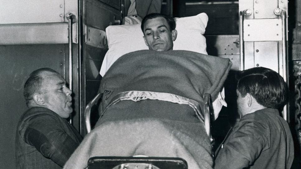 (Original Caption) Golf champion Ben Hogan is lifted from a train which brought him to his home town to recuperate from a near fatal auto accident. He was hospitalized in early February.