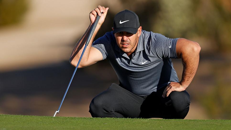SCOTTSDALE, ARIZONA - FEBRUARY 04: Brooks Koepka of the United States lines up a putt on the 14th hole during the first round of the Waste Management Phoenix Open at TPC Scottsdale on February 04, 2021 in Scottsdale, Arizona. (Photo by Christian Petersen/Getty Images)