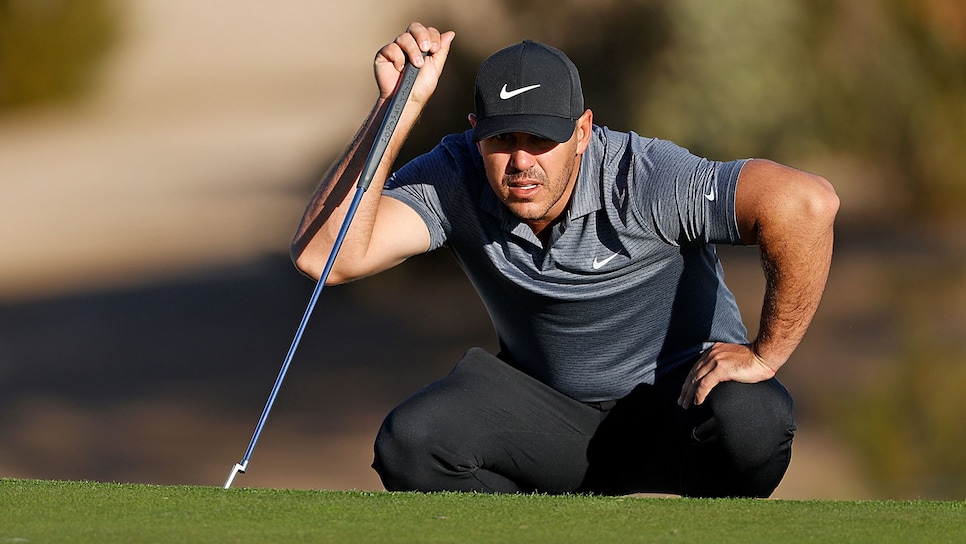 SCOTTSDALE, ARIZONA - FEBRUARY 04: Brooks Koepka of the United States lines up a putt on the 14th hole during the first round of the Waste Management Phoenix Open at TPC Scottsdale on February 04, 2021 in Scottsdale, Arizona. (Photo by Christian Petersen/Getty Images)