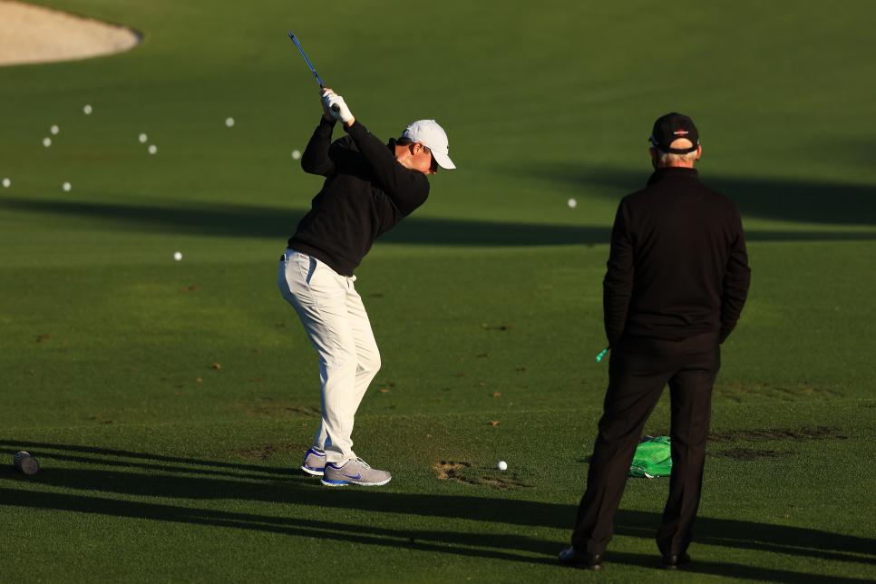 AUGUSTA, GEORGIA - APRIL 05: Rory McIlroy of Northern Ireland works with coach Pete Cowen on the range during a practice round prior to the Masters at Augusta National Golf Club on April 05, 2021 in Augusta, Georgia. (Photo by Mike Ehrmann/Getty Images)