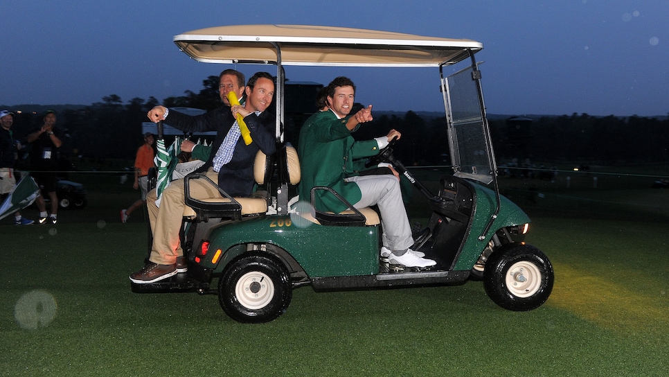 Adam Scott of Australia (front-R) leaves to give a press conference while wearing his green jacket after winning the 2013 Masters Tournament at Augusta National Golf Club on April 14, 2013 in Augusta, Georgia. Scott of Australia sank a 10-foot birdie putt on the second playoff hole Sunday to beat Angel Cabrera and win the 77th Masters, becoming the first Australian golfer to capture the green jacket. AFP PHOTO/Jewel Samad        (Photo credit should read JEWEL SAMAD/AFP via Getty Images)