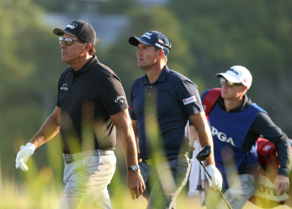 KIAWAH ISLAND, SOUTH CAROLINA - MAY 21: Phil Mickelson (L) of the United States and Padraig Harrington (C) of Ireland walk off the tenth tee during the second round of the 2021 PGA Championship at Kiawah Island Resort's Ocean Course on May 21, 2021 in Kiawah Island, South Carolina. (Photo by Jamie Squire/Getty Images)