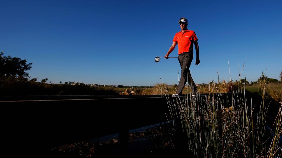 FARO, PORTUGAL - OCTOBER 11:  David Lynn of England walks on a bridge after he hits his tee shot on the 17th hole during the second round of the Portugal Masters at Oceanico Victoria Golf Course on October 11, 2013 in Faro, Portugal.  (Photo by Dean Mouhtaropoulos/Getty Images)