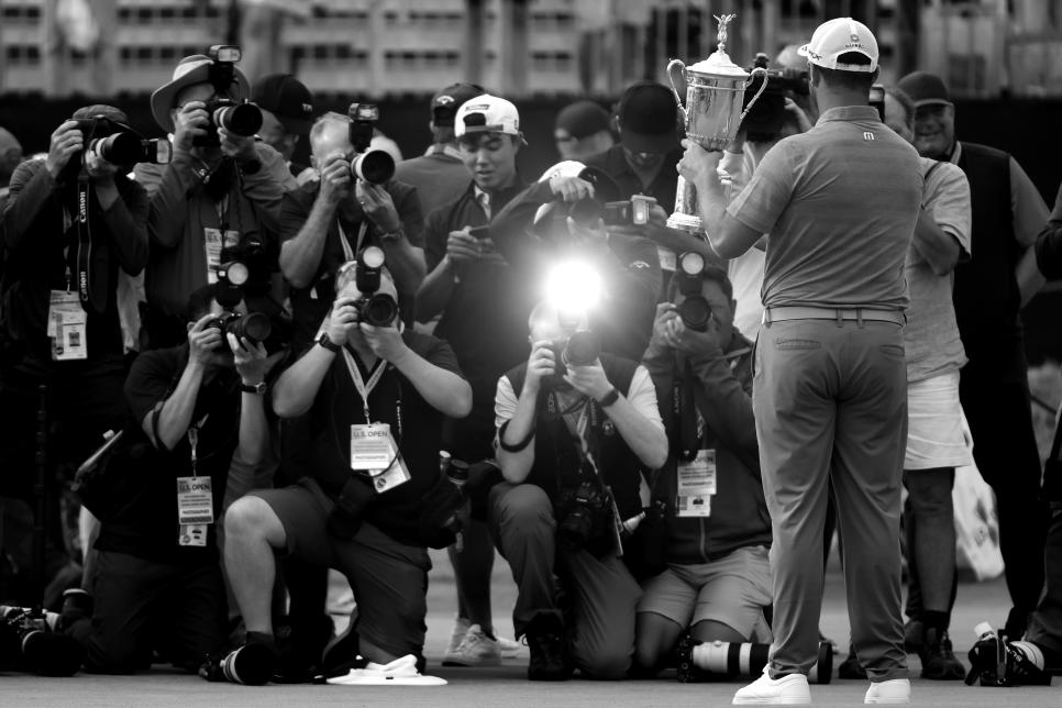 SAN DIEGO, CALIFORNIA - JUNE 20: (EDITOR'S NOTE: This image had been converted to black and white) Jon Rahm of Spain celebrates with the trophy after winning as the media takes photographs during the trophy presentation ceremony after the final round of the 2021 U.S. Open at Torrey Pines Golf Course (South Course) on June 20, 2021 in San Diego, California. (Photo by Sean M. Haffey/Getty Images)