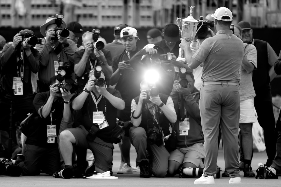 SAN DIEGO, CALIFORNIA - JUNE 20: (EDITOR'S NOTE: This image had been converted to black and white) Jon Rahm of Spain celebrates with the trophy after winning as the media takes photographs during the trophy presentation ceremony after the final round of the 2021 U.S. Open at Torrey Pines Golf Course (South Course) on June 20, 2021 in San Diego, California. (Photo by Sean M. Haffey/Getty Images)