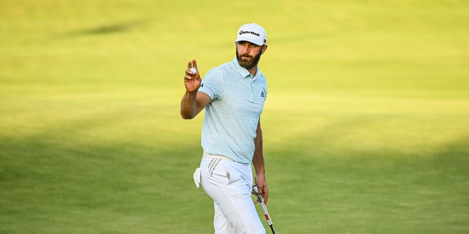 SANDWICH, ENGLAND - JULY 16:  Dustin Johnson waves his ball to fans after making a birdie putt on the 18th hole green during Day Two of the 149th The Open Championship at Royal St. Georges Golf Club on July 16, 2021 in Sandwich, England. (Photo by Keyur Khamar/PGA TOUR via Getty Images)