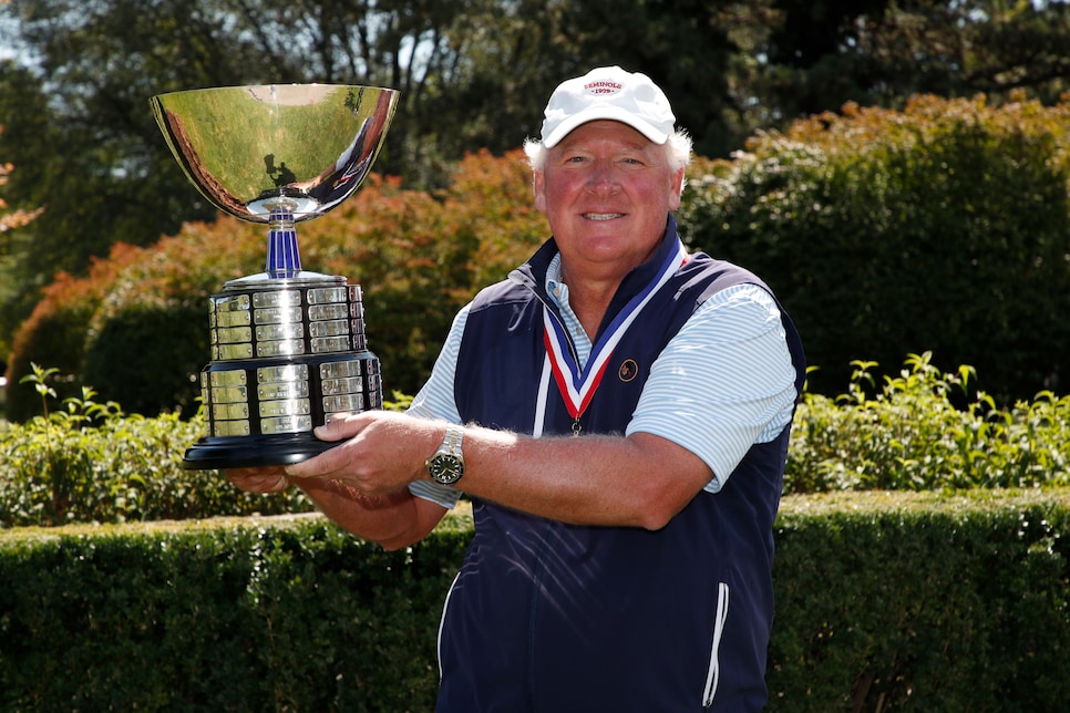 https://golfdigest.sports.sndimg.com/content/dam/images/golfdigest/fullset/2021/9/gene-elliott-us-senior-amateur-2021-trophy.jpg.rend.hgtvcom.966.644.suffix/1630613340151.jpeg