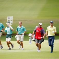 ATLANTA, GEORGIA - SEPTEMBER 05: Joaquin Niemann of Chile and caddie Gary Mathews jog on the 18th hole during the final round of the TOUR Championship on September 05, 2021 in Atlanta, Georgia. Niemann played his round in 1 hour 53 minutes.  (Photo by Cliff Hawkins/Getty Images)