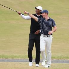 ST ANDREWS, SCOTLAND - JULY 11: Tiger Woods of The United States and Rory McIlroy of Northern Ireland interact on the 18th during the Celebration of Champions Challenge during a practice round prior to The 150th Open at St Andrews Old Course on July 11, 2022 in St Andrews, Scotland. (Photo by Warren Little/Getty Images)