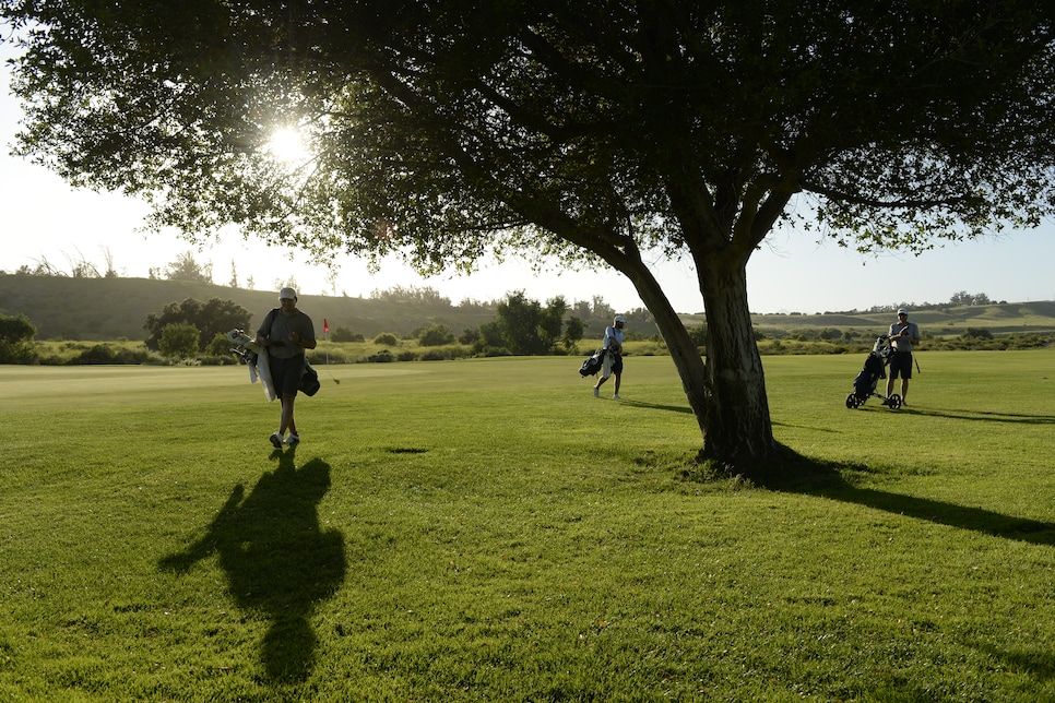 golfer-walking-ahead-of-group