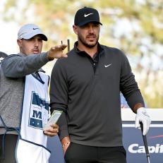 LAS VEGAS, NEVADA - NOVEMBER 26: Brooks Koepka and his caddie Chase Koepka line up a shot during Capital One's The Match V: Bryson v Brooks at Wynn Golf Course on November 26, 2021 in Las Vegas, Nevada. (Photo by David Becker/Getty Images for The Match)