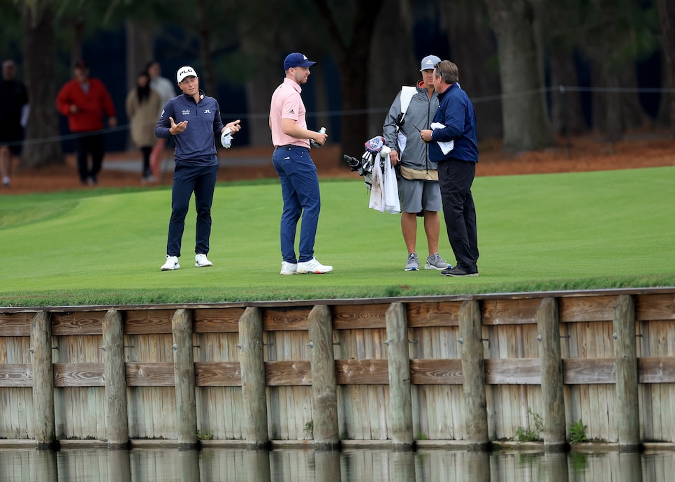 PONTE VEDRA BEACH, FLORIDA - MARCH 14: Viktor Hovland of Norway watches on as his playing partner Daniel Berger debates with Gary Young the PGA Tour rules official as to where his ball had crossed the water hazard for Berger's second shot on the par 5, 16th hole during the final round of THE PLAYERS Championship at TPC Sawgrass on March 14, 2022 in Ponte Vedra Beach, Florida. (Photo by David Cannon/Getty Images)