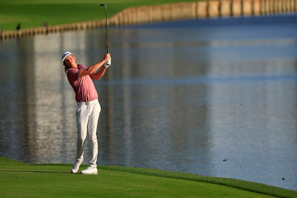 PONTE VEDRA BEACH, FLORIDA - MARCH 14: Cameron Smith of Australia plays an approach shot on the 18th fairway during the final round of THE PLAYERS Championship on the Stadium Course at TPC Sawgrass on March 14, 2022 in Ponte Vedra Beach, Florida. (Photo by Mike Ehrmann/Getty Images)