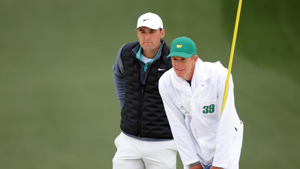 AUGUSTA, GEORGIA - APRIL 09: Scottie Scheffler and caddie Ted Scott line up a putt on the seventh green during the third round of the Masters at Augusta National Golf Club on April 09, 2022 in Augusta, Georgia. (Photo by Jamie Squire/Getty Images)