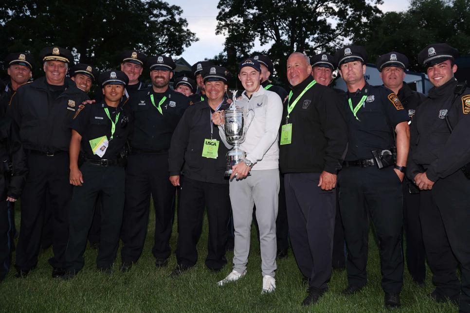 BROOKLINE, MASSACHUSETTS - JUNE 19: Matt Fitzpatrick of England poses with the U.S. Open Championship trophy alongside security from the Brookline Police Department after winning during the final round of the 122nd U.S. Open Championship at The Country Club on June 19, 2022 in Brookline, Massachusetts. (Photo by Warren Little/Getty Images)