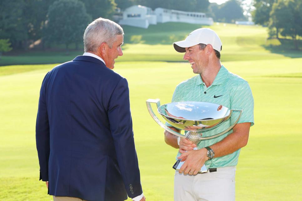 ATLANTA, GEORGIA - AUGUST 28: Rory McIlroy of Northern Ireland celebrates with the FedEx Cup and PGA Tour Commissioner Jay Monahan after winning during the final round of the TOUR Championship at East Lake Golf Club on August 28, 2022 in Atlanta, Georgia. (Photo by Kevin C. Cox/Getty Images)