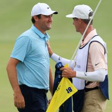 PONTE VEDRA BEACH, FLORIDA - MARCH 12: Scottie Scheffler of the United States celebrates with caddie Ted Scott after winning on the 18th green during the final round of THE PLAYERS Championship on THE PLAYERS Stadium Course at TPC Sawgrass on March 12, 2023 in Ponte Vedra Beach, Florida. (Photo by Sam Greenwood/Getty Images)