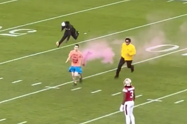 Two LA Rams players brutally tackle a streaker carrying a smoke bomb