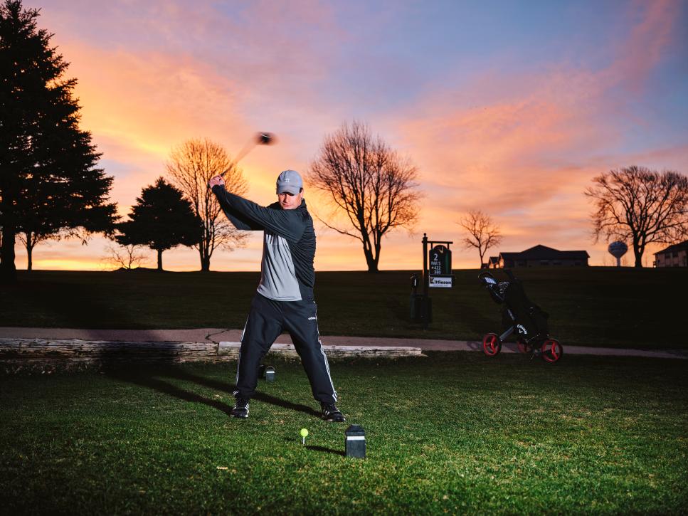 Nolan Krentz plays golf just before sunrise at Norsk Golf in Mount Horeb, Wisconsin, Friday, April 14, 2023. In 2022, Krentz played over 18,000 holes of golf. Photo by Matt Nager