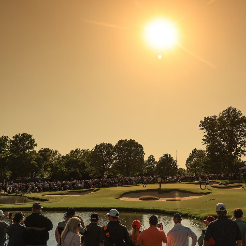 TULSA, OKLAHOMA - MAY 22: EDITORS NOTE: A GRADUATED COLOUR FILTER USED IN THIS IMAGE: A general view of spectators watching Justin Thomas of The United States and Will Zalatoris putt on the 13th hole, the first hole of the sudden-death play-off during the final round of the 2022 PGA Championship at Southern Hills Country Club on May 22, 2022 in Tulsa, Oklahoma. (Photo by David Cannon/Getty Images)