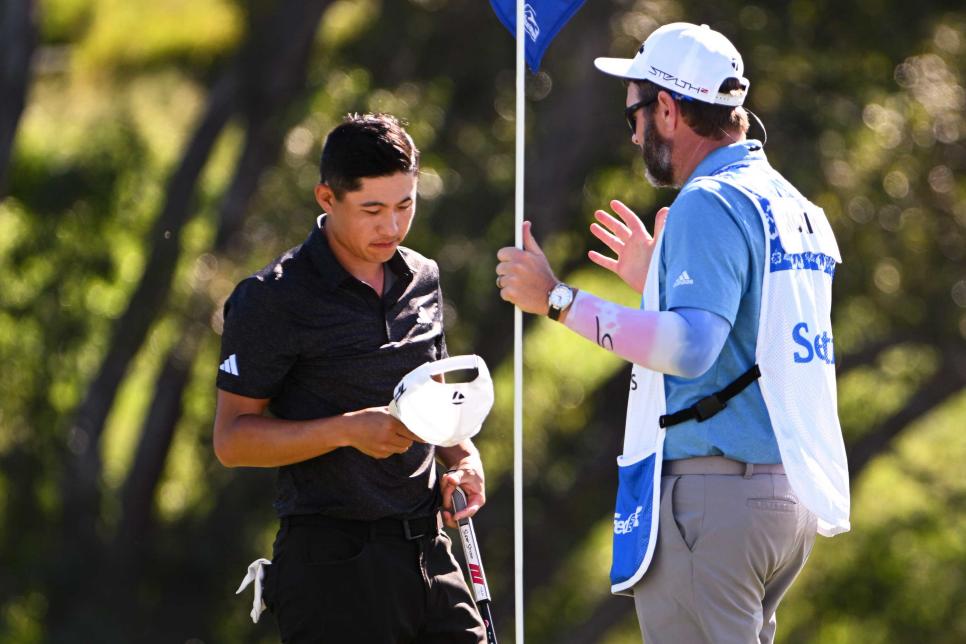 KAPALUA, MAUI - HI - JANUARY 08: J.J. Jakovac, caddie for Collin Morikawa, talks with him on the 18th green after Collin lost a large lead during the final round of the Sentry Tournament of Champions on The Plantation Course at Kapalua on January 8, 2023 in Kapalua, Maui, Hawaii. (Photo by Tracy Wilcox/PGA TOUR via Getty Images)