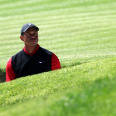 PACIFIC PALISADES, CALIFORNIA - FEBRUARY 19: Tiger Woods of the United States reacts to his shot out of a bunker on the 17th hole during the final round of the Genesis Invitational at Riviera Country Club on February 19, 2023 in Pacific Palisades, California. (Photo by Harry How/Getty Images)