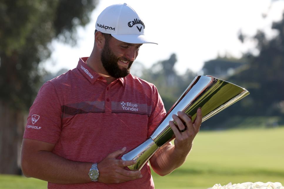 PACIFIC PALISADES, CALIFORNIA - FEBRUARY 19: Jon Rahm of Spain celebrates with the trophy after putting in to win The Genesis Invitational at Riviera Country Club on the 18th green on February 19, 2023 in Pacific Palisades, California. (Photo by Harry How/Getty Images)