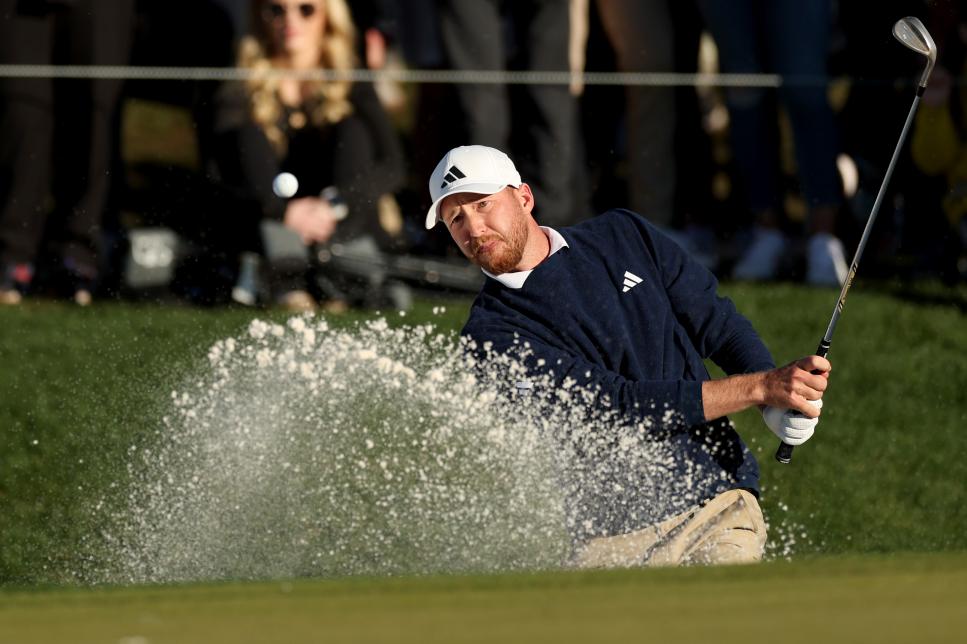 SCOTTSDALE, ARIZONA - FEBRUARY 11: Daniel Berger of the United States plays a shot from a bunker on the 18th hole during the final round of the WM Phoenix Open at TPC Scottsdale on February 11, 2024 in Scottsdale, Arizona. (Photo by Christian Petersen/Getty Images)
