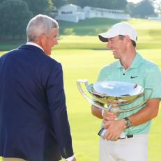 ATLANTA, GEORGIA - AUGUST 28: Rory McIlroy of Northern Ireland celebrates with the FedEx Cup and PGA Tour Commissioner Jay Monahan after winning during the final round of the TOUR Championship at East Lake Golf Club on August 28, 2022 in Atlanta, Georgia. (Photo by Kevin C. Cox/Getty Images)