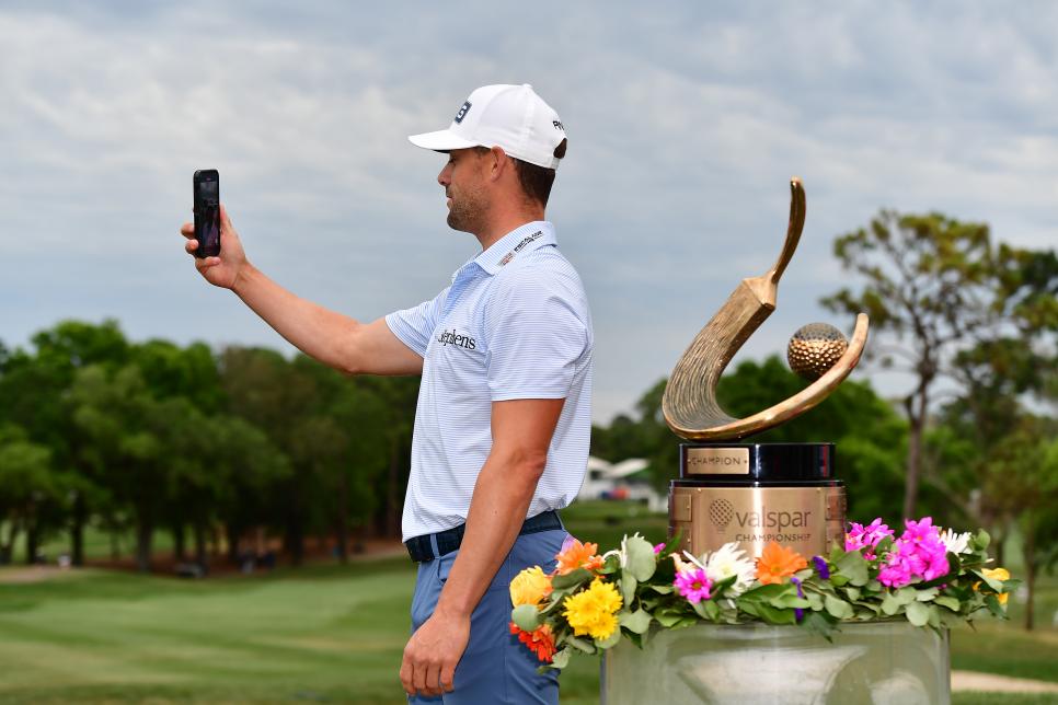 PALM HARBOR, FLORIDA - MARCH 19: Taylor Moore of the United States celebrates with the trophy after winning during the final round of the Valspar Championship at Innisbrook Resort and Golf Club on March 19, 2023 in Palm Harbor, Florida. (Photo by Julio Aguilar/Getty Images)