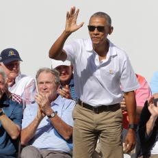 JERSEY CITY, NJ - SEPTEMBER 28:  Former U.S. President Barack Obama waves to the crowd as former U.S. Presidents Bill Clinton (L) and George W. Bush (2ndL) look on during Thursday foursomes matches of the Presidents Cup at Liberty National Golf Club on September 28, 2017 in Jersey City, New Jersey.  (Photo by Sam Greenwood/Getty Images)