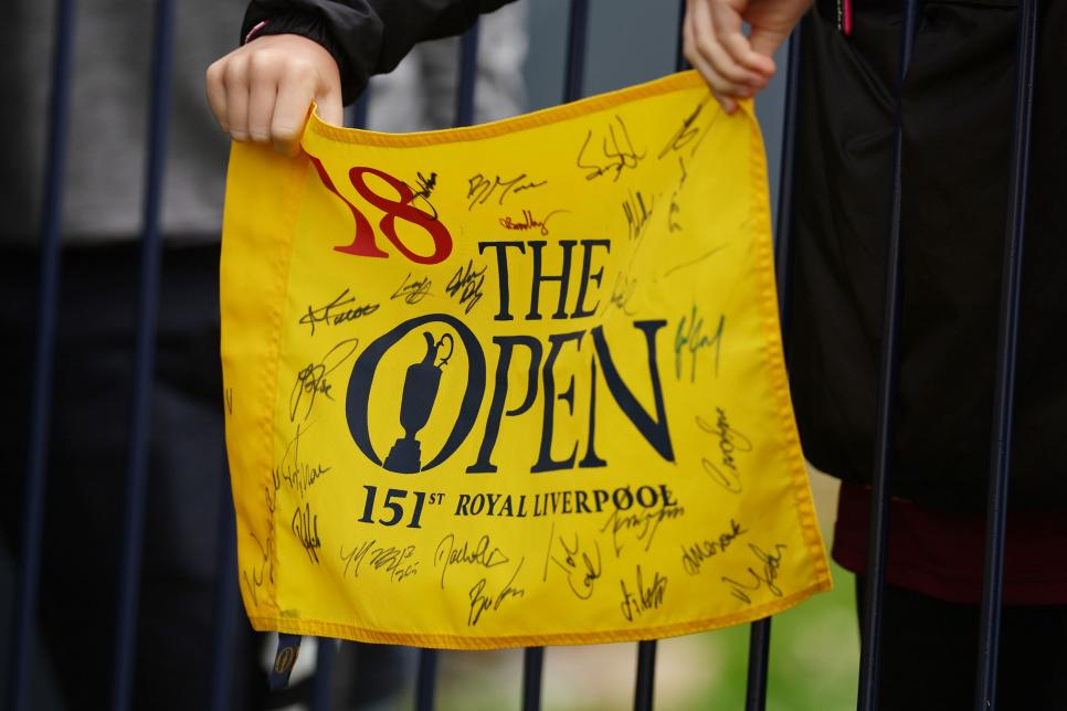 HOYLAKE, ENGLAND - JULY 19: Fans hold yellow 18th hole flags during a practice round prior to The 151st Open at Royal Liverpool Golf Club on July 19, 2023 in Hoylake, England. (Photo by Andrew Redington/Getty Images)