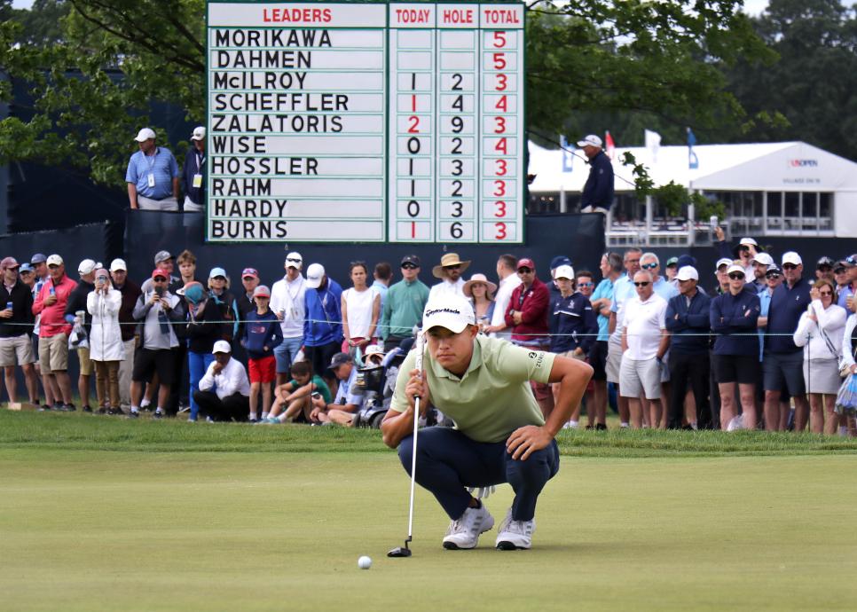 Brookline, MA - June 18: The leader board looms behind Colin Morikawa as he lines up his putt on the 1st green. The third round of the US Open at The Country Club in Brookline, MA on June 18, 2022. (Photo by John Tlumacki/The Boston Globe via Getty Images)