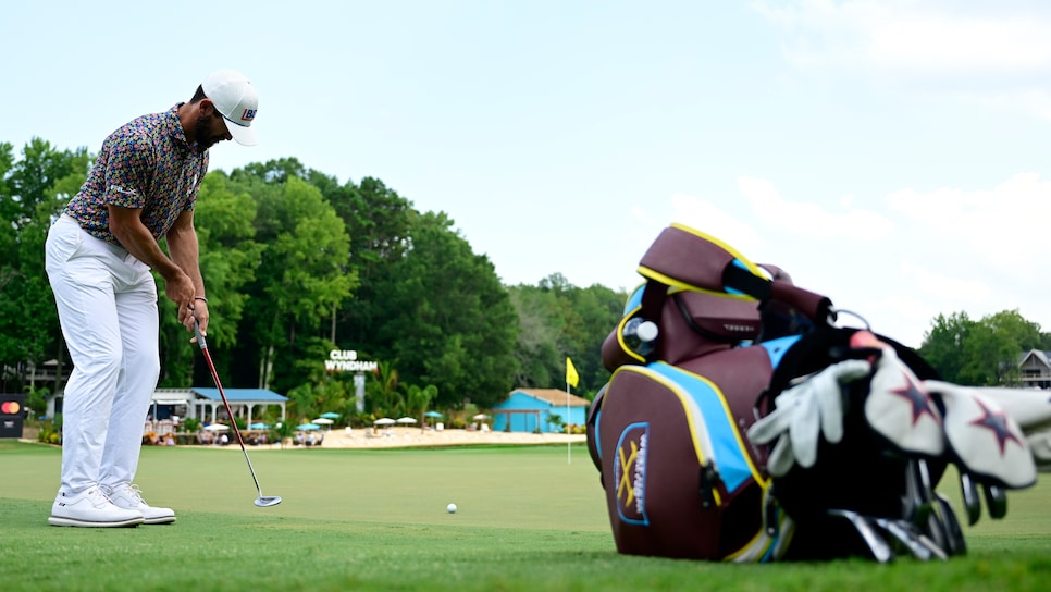 Billy Horschel picks up golf ball with putter in a never-before