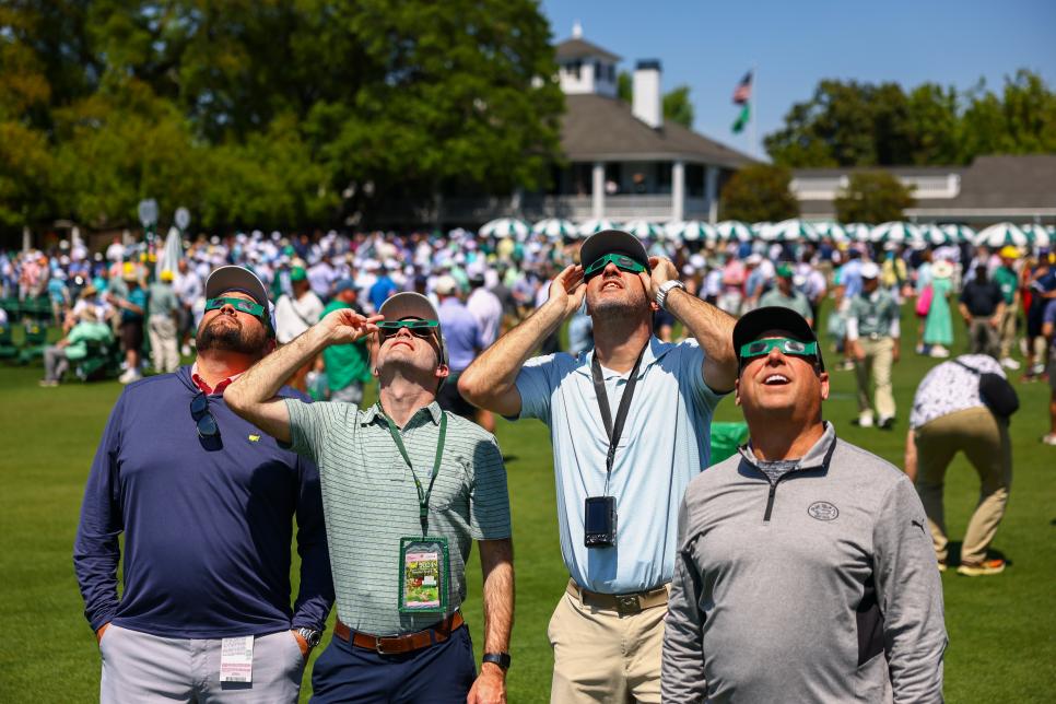 Patrons looks at the eclipse during the a practice round of the 2024 Masters Tournament held in Augusta, GA at Augusta National Golf Club on Monday, April 8, 2024.
